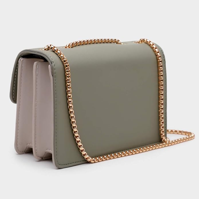 Green handbag with a gold chain strap on a light gray background