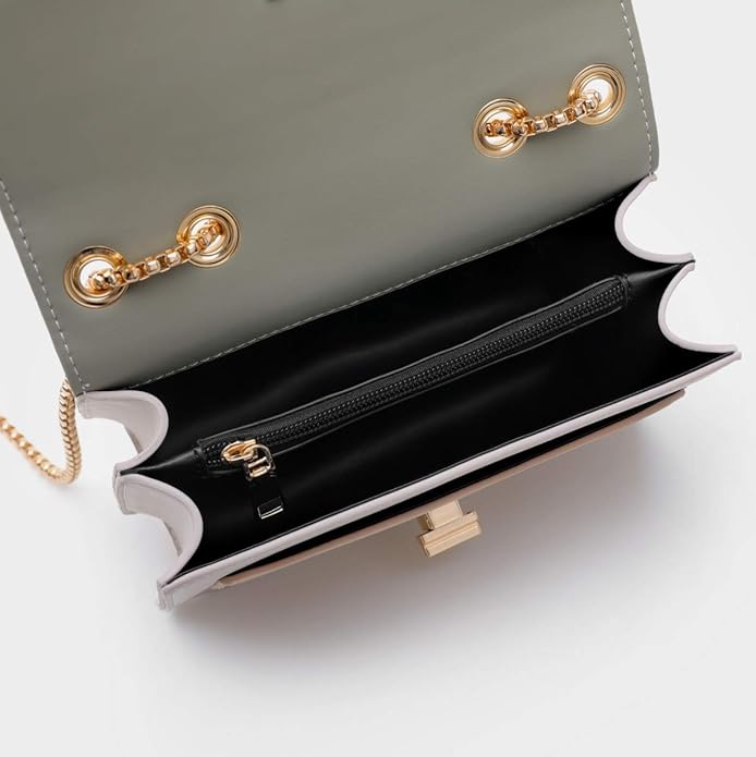 Gray handbag with gold hardware on a white background