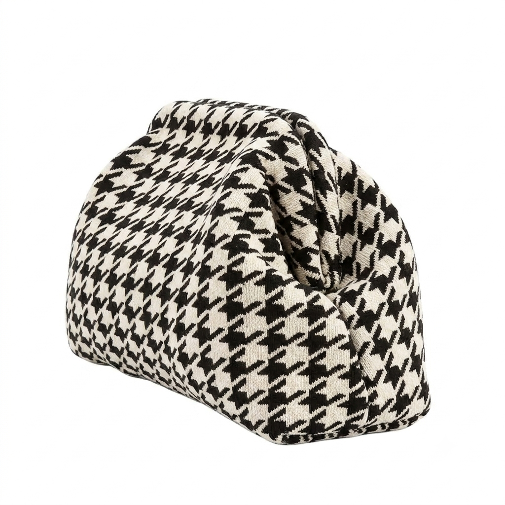 Houndstooth patterned wedge-shaped door stopper on a white background