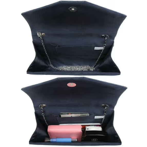 Black handbag with chain detail, open to reveal pink and black items on a white background